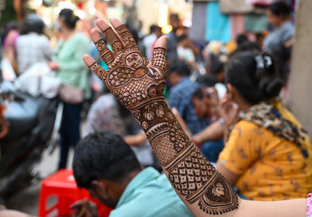 GURUGRAM, INDIA - OCTOBER 19: A woman applies 'henna' on her hands on the eve of 'Karva Chauth'...