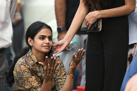 NEW DELHI, INDIA - OCTOBER 19: Women get applying mehndi on their hands on the eve of 'Karvachauth',...