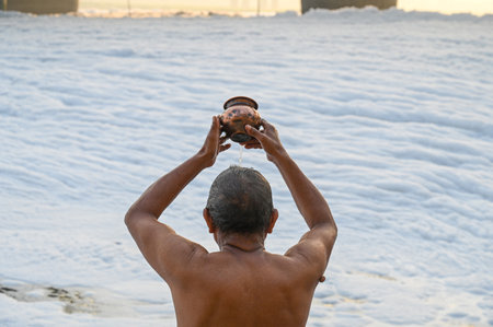NEW DELHI, INDIA - OCTOBER 26: The Yamuna River is frequently blanketed with a toxic foam from untreated industrial wastes. But worshipers offering water to Lord Surya at Kalindi Kun Ghat, on October 26, 2024 in New Delhi, India. (Photo by Sunil Ghosh/Hinのeditorial素材