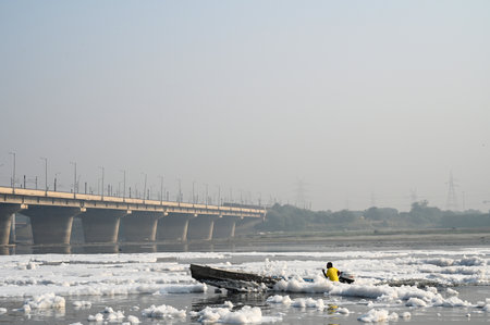 NEW DELHI, INDIA - OCTOBER 24: Local Seafarer row their boat at the Yamuna River that is covered by froth from discharge of untreated industrial and domestic waste on October 24, 2024 in New Delhi, India. (Photo by Sunil Ghosh/Hindustan Times )のeditorial素材
