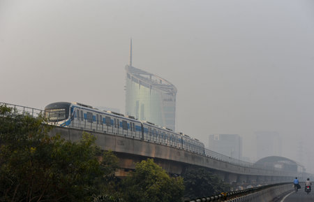 GURUGRAM, INDIA - OCTOBER 27: A rapid metro train runs amid a thick layer of smog engulfed on...