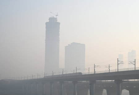 NOIDA INDIA OCTOBER 29 2024 A view of skyscrapers covered in a morning haze due to rising air...