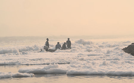 NEW DELHI, INDIA - NOVEMBER 3: Local fishermen row their boats as toxic foam floats on the surface of the Yamuna River at Kalindi Kunj on November 3, 2024 in New Delhi, India. The Yamuna River is inundated with toxic foam ahead of Chhath Puja, set to be cのeditorial素材