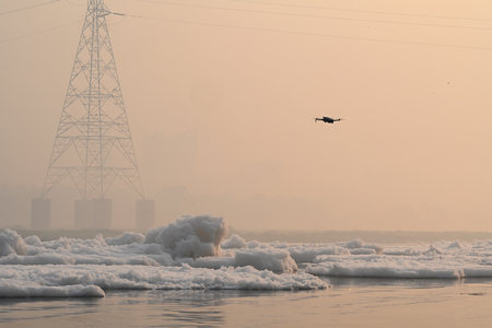 NEW DELHI, INDIA - NOVEMBER 3: A view of the Yamuna River covered in toxic foam from untreated industrial and domestic waste at Kalindi Kunj on November 3, 2024 in New Delhi, India. The Yamuna River is inundated with toxic foam ahead of Chhath Puja, set tのeditorial素材