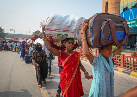 NEW DELHI INDIA NOVEMBER 5 2024 Crowds of People arrives to board the trains to reach their...