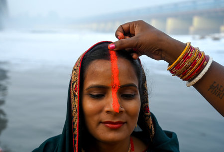 NOIDA INDIA NOVEMBER 8 2024 Devotees performing the rituals of offering Arghya to the rising sun in the Yamuna River on the fourth and last day of Chhath Puja A festival dedicated to Lord Surya Chhath Puja is celebrated with rich rituals over four days Roのeditorial素材