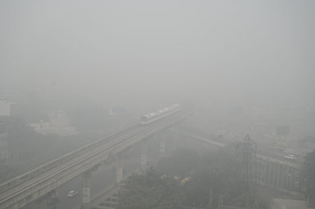 GURUGRAM, INDIA - NOVEMBER 18:  A Metro train passes amid the thick layers of smog seen engulfed at...