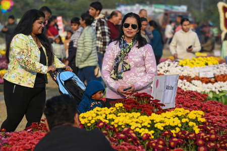NOIDA, INDIA - DECEMBER 15: Visitors seen on the second day of the first Noida Chrysanthemum Flower Exhibition organized by Noida Authority at Sector 33 Helipad Ground, on December 15, 2024 in Noida, India. This event promises to be a mesmerizing celebratのeditorial素材