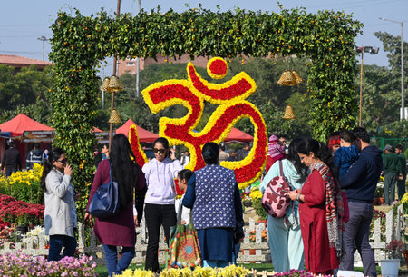 NOIDA, INDIA - DECEMBER 14: On the day of the first Noida Chrysanthemum Flower Exhibition organized by the Noida Authority at the Sector 33 helipad ground, people enjoying the flower exhibition by taking photographs with the figures made of flowers, on Deのeditorial素材
