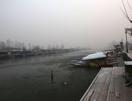SRINAGAR INDIA DECEMBER 21 2024 A view of a frozen surface parts of Dal Lake on December 21 2024 in Srinagar India Kashmir is in the grip of a cold wave and the 40 day period of Chillai Kalan major cold began in the Valley on an icy note with Srinagar witのeditorial素材