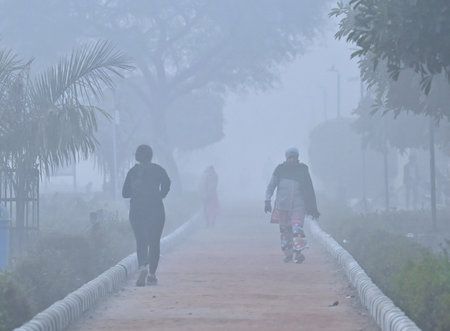 NEW DELHI INDIA DECEMBER 22 2024 Morning Walkers brave the early morning winter fog in Dwarka on December 22 2024 in New Delhi India Delhi NCR experienced a foggy morning on Sunday with the minimum temperature recorded at 7 3 degrees Celcius two notches bのeditorial素材