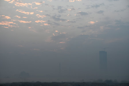 NOIDA INDIA DECEMBER 22 2024 Commuters step out in foggy winter cold morning amid rising air pollution at sector 25 road on December 22 2024 in Noida India Delhi NCR experienced a foggy morning on Sunday with the minimum temperature recorded at 7 3 degreeのeditorial素材