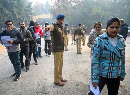 NOIDA INDIA DECEMBER 22 2024 Aspirants appearing for the UPPSC PCS Prelims exam 2024 are frisked and...