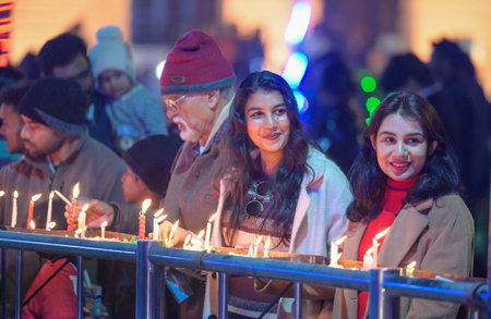 NEW DELHI INDIA DECEMBER 24 2024 Devotees light candles during the cold Rain at the Sacred Heart Cathedral Church on the eve of Christmas Day celebrations on December 24 2024 in New Delhi India Photo by Raj K Raj Hindustan Timesのeditorial素材