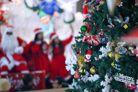 NOIDA INDIA DECEMBER 24 2024 Actors dressed as Santa Claus Santa girls and cartoon character enjoy...