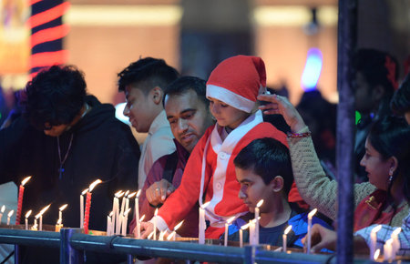 NEW DELHI INDIA DECEMBER 24 2024 Devotees light candles at the Sacred Heart Cathedral Church on the...
