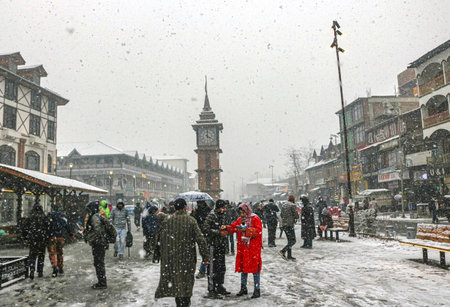 SRINAGAR, INDIA - DECEMBER 27: People enjoying at the Ghanta Ghar during the first snowfall of the season on December 27, 2024 in Srinagar, India. Minimum temperatures decreased at most places in Kashmir as the valley continued to reel under intense cold のeditorial素材