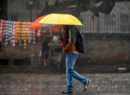 NOIDA, INDIA - DECEMBER 27: Commuters during winter rain in Sector 12, rain adds to severe cold wave in North India Several parts of Delhi-NCR received rainfall in the morning, on December 27, 2024 in Noida, India. Delhi and nearby areas received moderateのeditorial素材