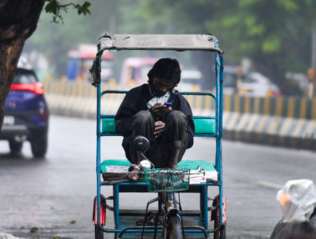 NOIDA, INDIA - DECEMBER 27: Commuters during winter rain in Sector 27, on December 27, 2024 in Noida, India. Delhi and nearby areas received moderate to heavy rain on Friday, leading to a drop in temperatures. The India Meteorological Department (IMD) hasのeditorial素材