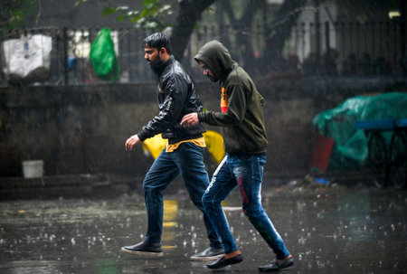 NOIDA, INDIA - DECEMBER 27: Commuters during winter rain in Sector 12, rain adds to severe cold wave...