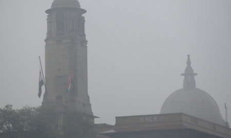NEW DELHI, INDIA - DECEMBER 27: National flag flies at half-mast at the North block and South block as one-week state mourning is being observed in the country as a mark of respect to former Prime Minister Manmohan singh on December 27, 2024 in New Delhi,のeditorial素材