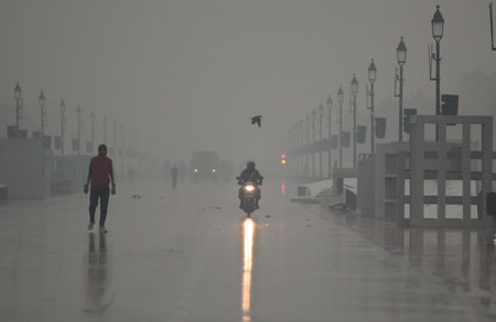 NEW DELHI, INDIA - DECEMBER 27: Commuters out in cold and rainy weather morning at Kartavya Path...