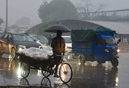 GURUGRAM, INDIA - DECEMBER 27: People going to their workplace amid rain on a winter morning at...