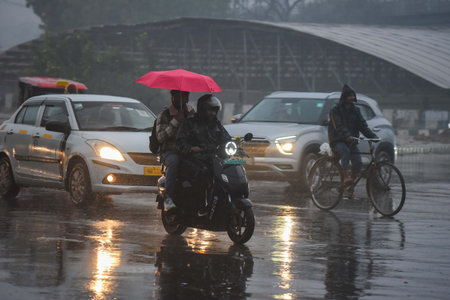 GURUGRAM, INDIA - DECEMBER 27: People going to their workplace amid rain on a winter morning at...
