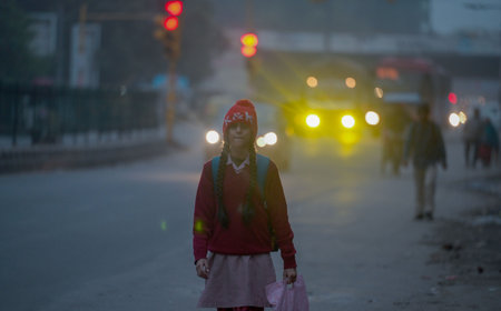 NEW DELHI, INDIA - DECEMBER 30: Student out on a cold winter morning, at Pandav Nagar on December 30, 2024 in New Delhi, India. North India is reeling under cold weather with temperatures plummeting across several states. As per IMD, the minimum temperatuのeditorial素材