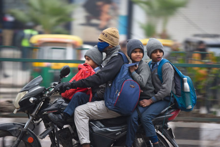 NEW DELHI, INDIA - DECEMBER 31: Students are going to school on a cold winter morning at Kapashera...