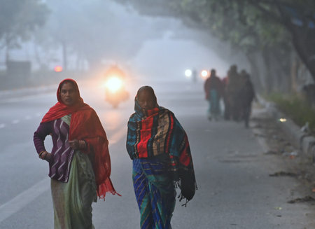 NEW DELHI, INDIA - JANUARY 5: Commuters brave the early morning Fog and Chill at Dwarka, on January 5, 2025 in New Delhi, India. A dense blanket of fog once again engulfed national capital Delhi on Saturday morning reducing the visibility to zero in severのeditorial素材