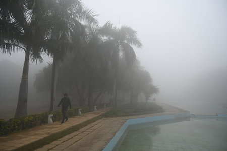 GURUGRAM, INDIA - JANUARY 5: People seen exercising amid cold and foggy weather in Leisure Valley Park at sector-29 near Huda Market, on January 5, 2025 in Gurugram, India. A dense blanket of fog once again engulfed national capital Delhi on Saturday mornのeditorial素材