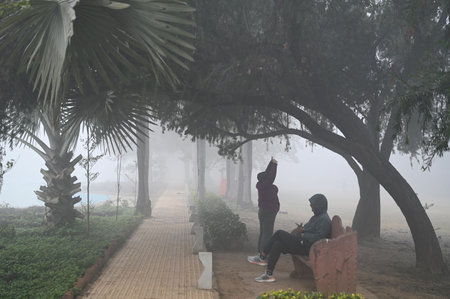 GURUGRAM, INDIA - JANUARY 5: People seen exercising amid cold and foggy weather in Leisure Valley Park at sector-29 near Huda Market, on January 5, 2025 in Gurugram, India. A dense blanket of fog once again engulfed national capital Delhi on Saturday mornのeditorial素材