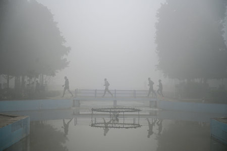 GURUGRAM, INDIA - JANUARY 5: People seen exercising amid cold and foggy weather in Leisure Valley Park at sector-29 near Huda Market, on January 5, 2025 in Gurugram, India. A dense blanket of fog once again engulfed national capital Delhi on Saturday mornのeditorial素材