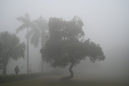 GURUGRAM, INDIA - JANUARY 5: People seen exercising amid cold and foggy weather in Leisure Valley Park at sector-29 near Huda Market, on January 5, 2025 in Gurugram, India. A dense blanket of fog once again engulfed national capital Delhi on Saturday mornのeditorial素材