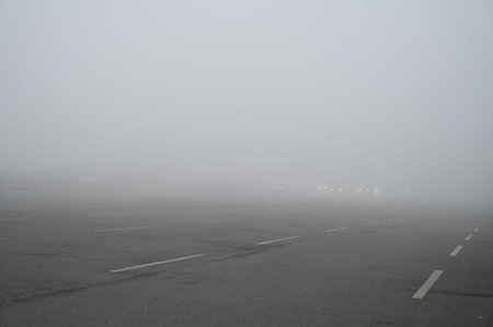 GURUGRAM, INDIA - JANUARY 4: Commuters travel in slow speed during the low visibility on a cold and dense fog condition at National Highway-48 near Ambience Mall, on January 4, 2025 in Gurugram, India. A dense blanket of fog once again engulfed national cのeditorial素材
