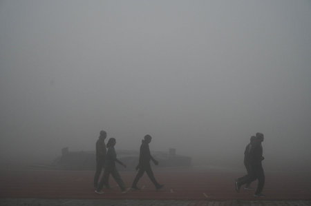 GURUGRAM, INDIA - JANUARY 4: Morning walkers seen amid cold and dense fog weather in Tau Devi Lal Stadium sector-38 near Rajiv chowk, on January 4, 2025 in Gurugram, India. A dense blanket of fog once again engulfed national capital Delhi on Saturday mornのeditorial素材
