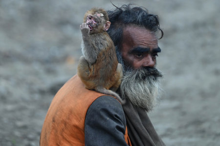 PRAYAGRAJ, INDIA - JANUARY 12: A saint carrying his pet monkey at Mahakumbh mela ground on January 12, 2025 in Prayagraj, India. The next Maha Kumbh Mela will take place in Prayagraj from January 13 to February 26, 2025. The festival is expected to attracのeditorial素材