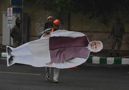 NEW DELHI, INDIA - JANUARY 11: People carrying cut outs of PM Modi during \"Jhuggi Basti Pradhan Sammelan\" at JLN Auditorium, on January 11, 2025 in New Delhi, India. Reacting to Arvind Kejriwal's prediction that former MP Ramesh Bidhuri will be the BJP'のeditorial素材