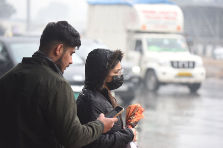 GURUGRAM, INDIA - JANUARY 11: Commuters on their way during the light rains at National Highway-48 near Rajiv chowk, on January 11, 2025 in Gurugram, India. (Photo by Parveen Kumar/Hindustan Times )のeditorial素材