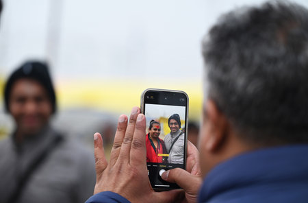 PRAYAGRAJ, INDIA - JANUARY 12: A man takes a selfie with Kinnar Saints at Mahakumbh Nagar on January 12, 2025 in Prayagraj, India. The next Maha Kumbh Mela will take place in Prayagraj from January 13 to February 26, 2025. The festival is expected to attrのeditorial素材