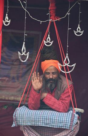 PRAYAGRAJ, INDIA - JANUARY 12:  A sadhu with ash smeared on his body sits inside his camp during...