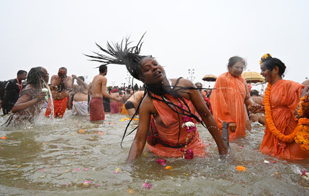 PRAYAGRAJ INDIA JANUARY 14 2025 Female SanyasinisÂ take holy dip at Sangam on the occasion of Makar Sankranti the confluence of the Ganges Yamuna and Saraswati rivers during the Maha Kumbh Mela on January 14 2025 in Prayagraj India The mega spiritual festのeditorial素材