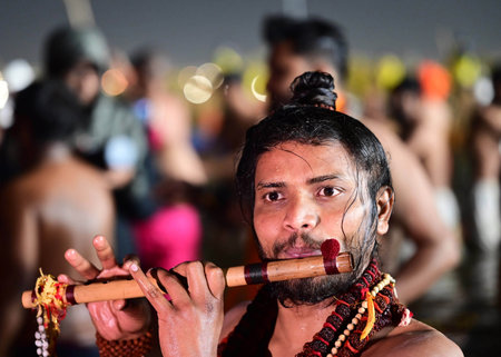 PRAYAGRAJ, INDIA - FEBRUARY 3: A sadhu playing flute afte taking a holy dip during the third ' Amrit bath' on the occasion of Basant Panchami at Triveni Sangam on February 3, 2025 in Prayagraj, India. (Photo by Deepak Gupta/Hindustan Times )のeditorial素材