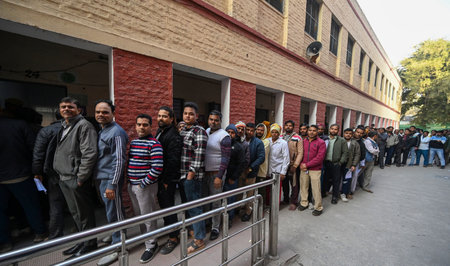 NEW DELHI INDIA FEBRUARY 5 2025 Voters stand in queue to cast their vote during Delhi Vidhan Sabha...