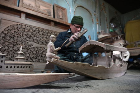 SRINAGAR INDIA FEBRUARY 24 2025 Walnut wood carving deaf mute artisan Mohammed Yousaf Muran works on a handcrafted walnut wood piece at his workshop in downtown area on February 24 2025 in Srinagar India Kashmir is home to the world s finest walnut wood aのeditorial素材