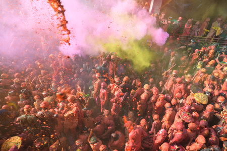 MATHURA, INDIA - MARCH 9: People smear each other with coloured powder Gulal during the Lathmar Holi...