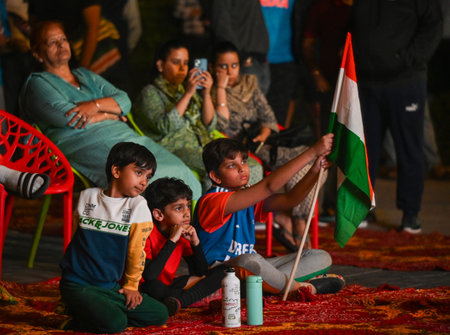 NOIDA INDIA MARCH 9 2025 People in cheerful mood while watching live telecast of the final match of...