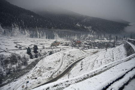 SRINAGAR, INDIA - MARCH 15: A view of a snow covered village at Gagangeer village of district Ganderbal, some 90 kms from Srinagar, on March 15, 2025 in Srinagar, India. Many areas in Kashmir, including the plains, received fresh snowfall, while other parのeditorial素材