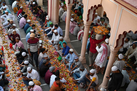 GURUGRAM, INDIA - MARCH 30: Muslim devotees sit in a queue during iftar time in the holy month of Ramadan at Jama Masjid in Sadar Bazaar near Sohna chowk, on March 30, 2025 in Gurugram, India. (Photo by Parveen Kumar/Hindustan Times )のeditorial素材